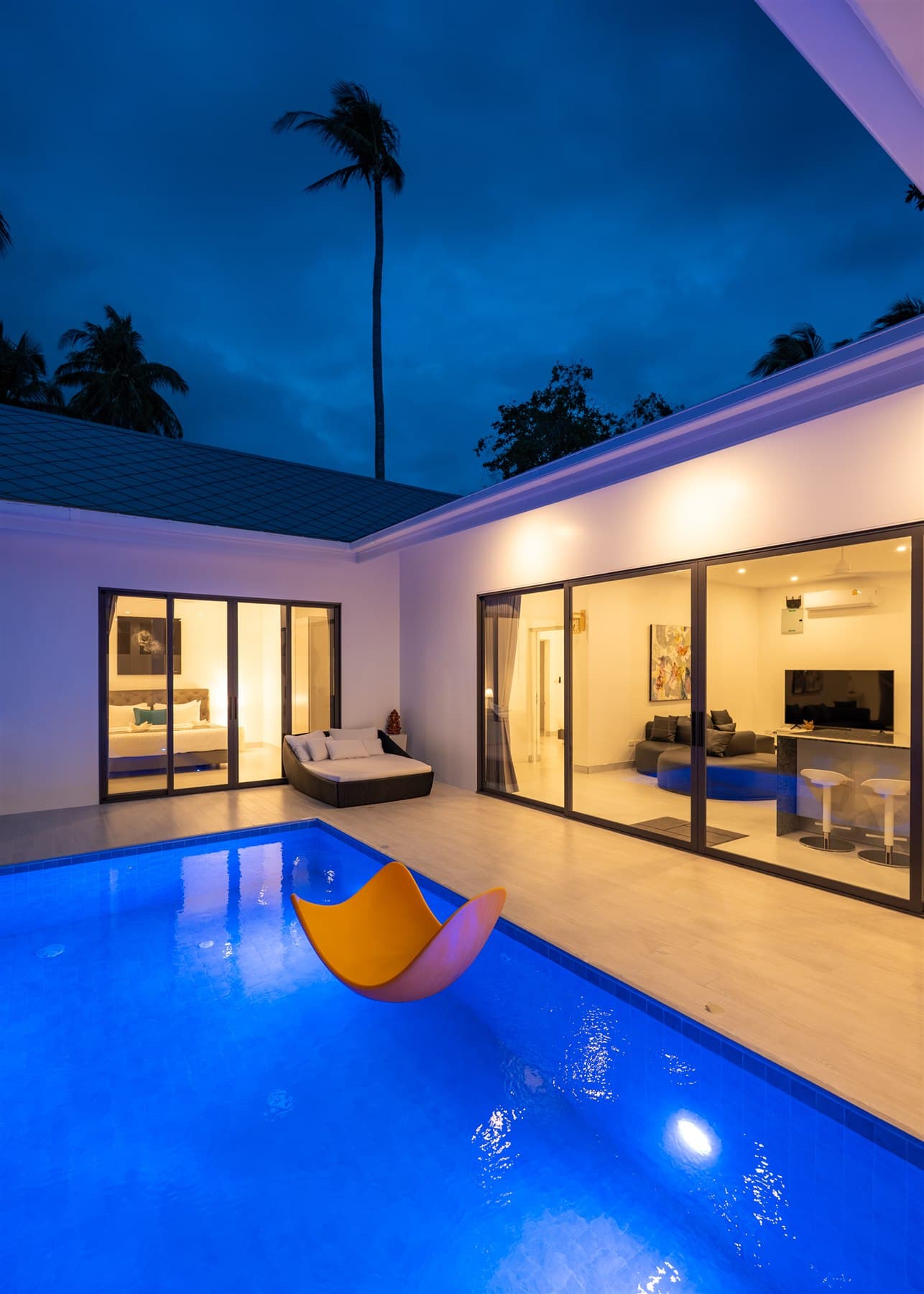 Three-bedroom villa illuminated at dusk